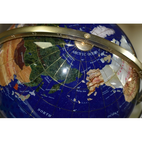 560 - A MODERN TABLE TOP TERRESTRIAL GLOBE, mounted in a brass gimbal stand / frame, height 36cm