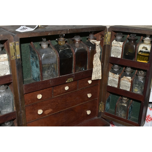 635 - AN EARLY 19TH CENTURY MAHOGANY APOTHECARY'S CABINET, with brass swan neck carrying handle to the top... 