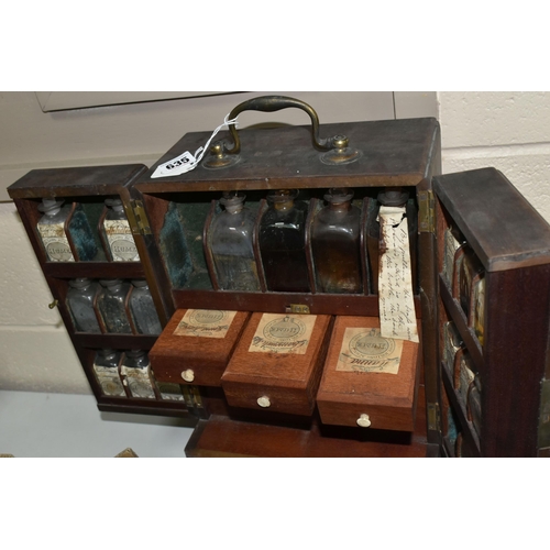 635 - AN EARLY 19TH CENTURY MAHOGANY APOTHECARY'S CABINET, with brass swan neck carrying handle to the top... 