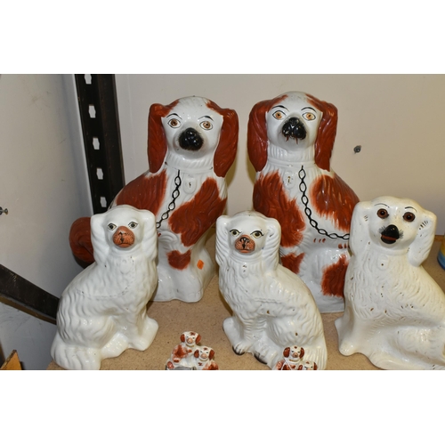 655 - SEVEN STAFFORDSHIRE/STYLE SPANIEL FIGURES, comprising a pair of small spaniel figure groups, each de... 