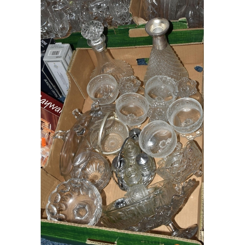 724 - SEVEN BOXES OF GLASSWARE,  a large quantity of mid-century glassware, to include decanters, floral t... 