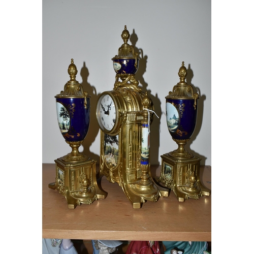 326 - A MODERN ITALIAN 'IMPERIAL' BRASS AND PORCELAIN CLOCK GARNITURE, the finials, columns and front all ... 