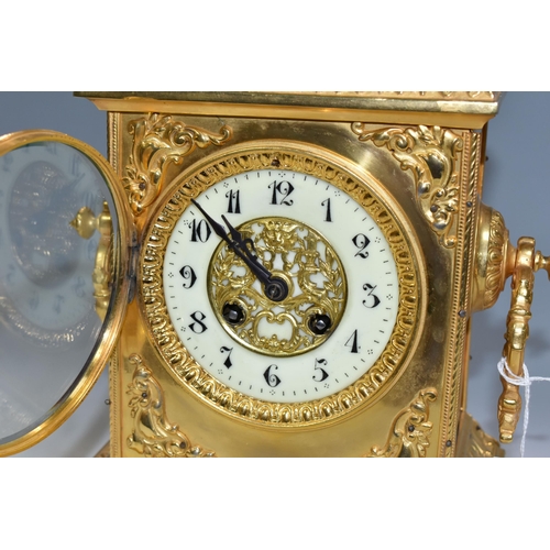 362 - AN EARLY 20TH CENTURY GILT METAL MANTEL CLOCK, the rectangular case with twin handled finial on a st... 