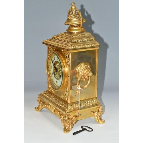 362 - AN EARLY 20TH CENTURY GILT METAL MANTEL CLOCK, the rectangular case with twin handled finial on a st... 