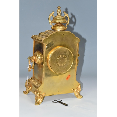 362 - AN EARLY 20TH CENTURY GILT METAL MANTEL CLOCK, the rectangular case with twin handled finial on a st... 