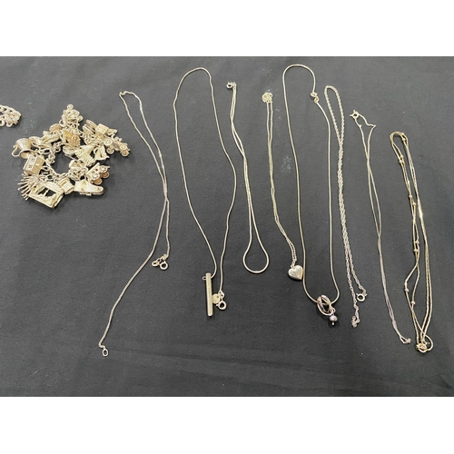 39 - A SELECTION OF SILVER AND WHITE METAL JEWELLERY, to include a charm bracelet suspending 21 charms wi... 