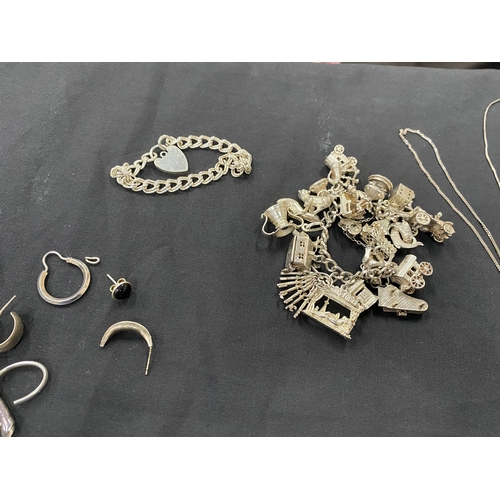 39 - A SELECTION OF SILVER AND WHITE METAL JEWELLERY, to include a charm bracelet suspending 21 charms wi... 