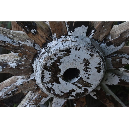 1007 - A WEATHERED CART/WAGGON WHEEL, diameter approximately 106cm (condition - weathered, losses to paint ... 