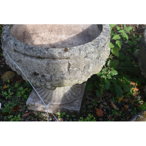 1010 - A PAIR OF COMPOSITE GARDEN URNS, with fruit and vine detail, diameter 43cm x height 39cm, along with... 