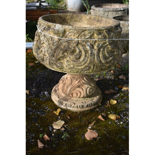 1011 - A PAIR OF COMPOSITE GARDEN URNS, with scrolled and foliate details, on a separate base, diameter 48c... 