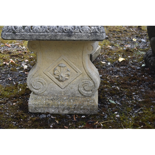 1015 - A RECONSTITUTED STONE FIVE PIECE GARDEN SUITE, comprising a circular table that rests on three seate... 