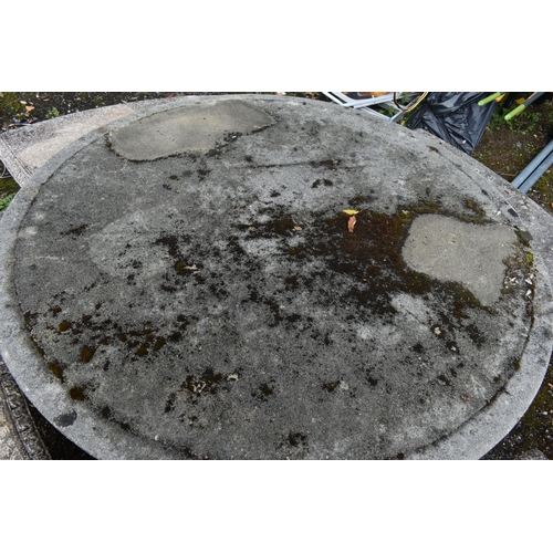 1015 - A RECONSTITUTED STONE FIVE PIECE GARDEN SUITE, comprising a circular table that rests on three seate... 