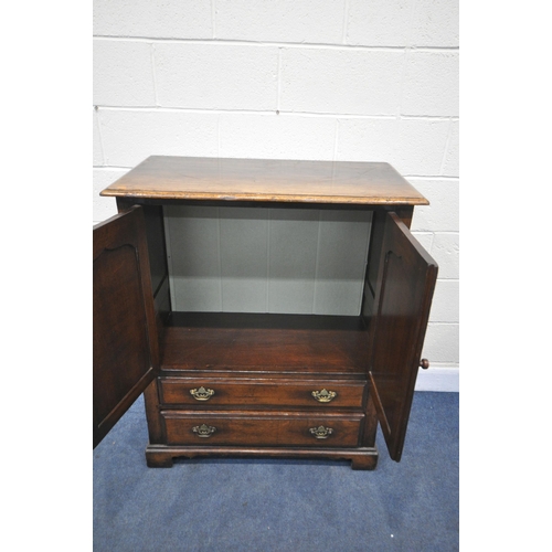 1228 - A REPRODUCTION PANELLED OAK TWO DOOR CABINET, with two drawers, width 95cm x depth 51cm x height 113... 