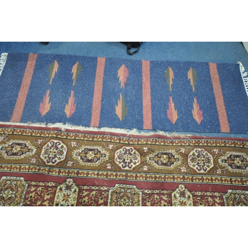 1274 - A LARGE WOOLLEN FLORAL RED AND GOLD RUG, 338cm x 247cm, and a blue wool carpet runner (condition rep... 