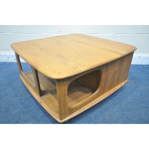 1299 - AN ERCOL ELM MODEL 735 PANDORA'S BOX ROLLING COFFEE TABLE, with an arrangement of drawer and storage... 