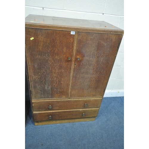 1305 - AN EARLY TO MID 20TH CENTURY OAK TWO DOOR CABINET, with two drawers, width 84cm x depth 47cm x heigh... 