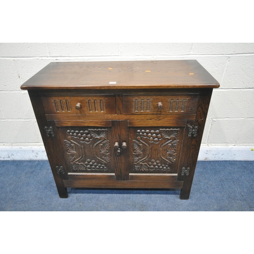 1310 - A CARVED OAK SIDEBOARD, with two drawers, width 93cm x depth 42cm x height 82cm (condition: good)