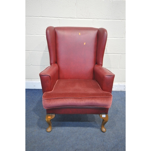 1311 - A RED LEATHERETTE WING BACK, with a fabric cushion, on beech cabriole legs