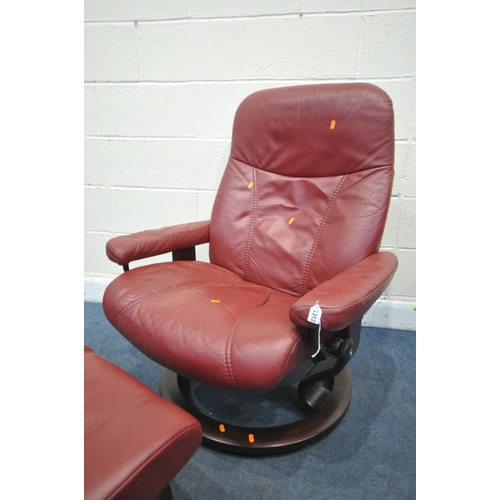 1312 - AN EKORNES STRESSLESS RED LEATHER RECLINING SWIVEL ARMCHAIR, and a footstool (condition report: chai... 