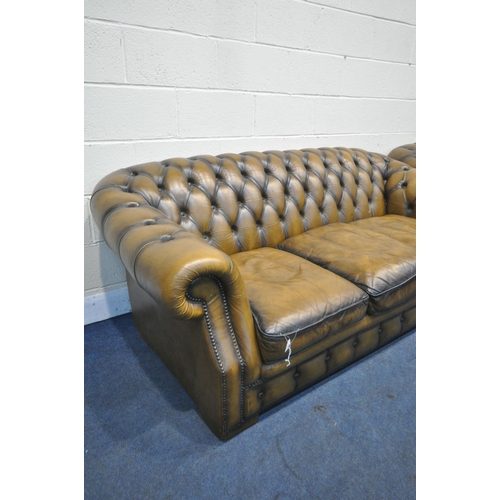 1314 - A MUSTARD LEATHER TWO PIECE CHESTERFIELD LOUNGE SUITE, comprising a three seater settee, length 200c... 