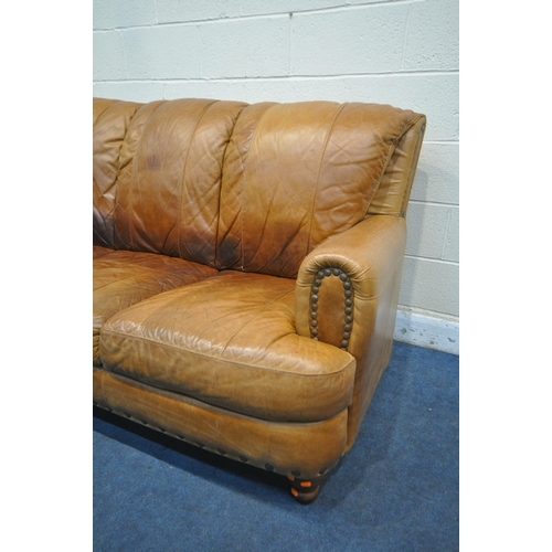 1315 - A TAN STUDDED LEATHER THREE SEATER SETTEE, length 184cm (condition report: cracks to arm rests, seat... 