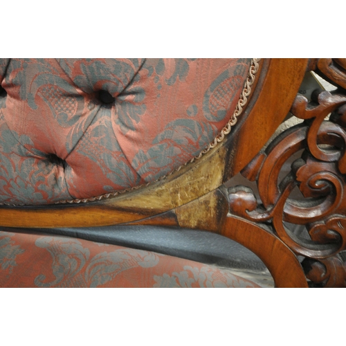 1319 - A VICTORIAN WALNUT BUTTONED SOFA, with open foliate decoration, on scrolled front legs, length 185cm... 