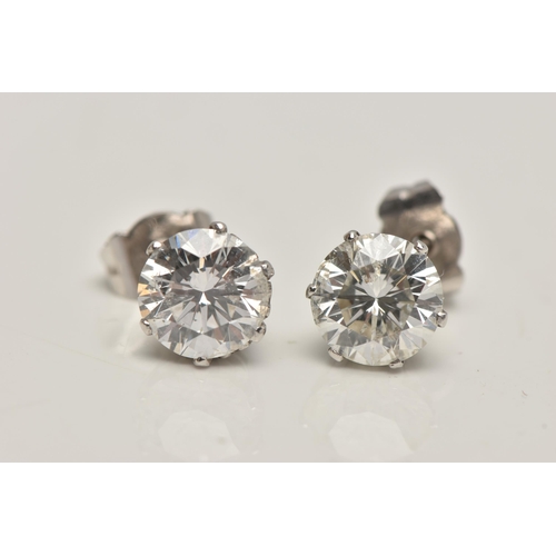 1 - A PAIR OF 18CT WHITE GOLD DIAMOND STUD EARRINGS, each round brilliant cut diamond in a six claw sett... 