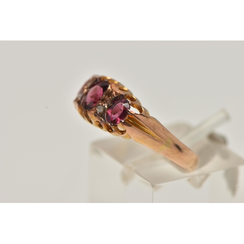 23 - AN EARLY 20TH CENTURY RUBY AND DIAMOND RING, set with three graduated oval cut rubies, interspaced w... 