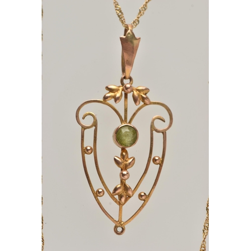 24 - AN EDWARDIAN PENDANT AND CHAIN, open work floral pendant, set with a circular cut peridot, missing d... 