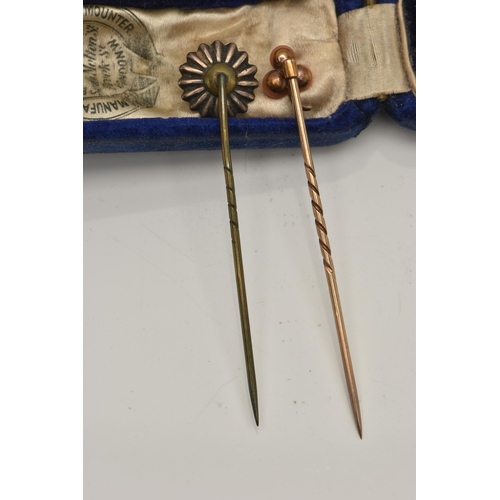 36 - TWO YELLOW METAL STICK PINS, the first set with coral cabochons, unmarked pin, the second of a circu... 