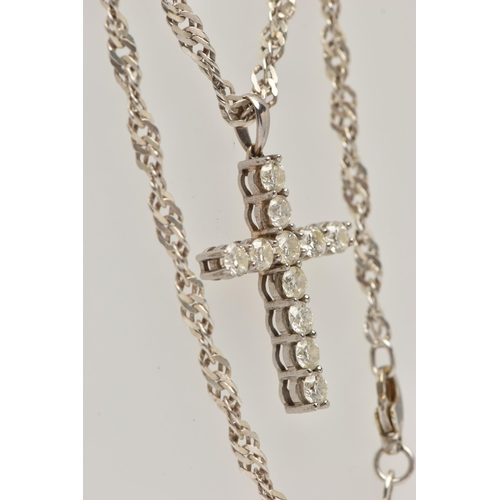 4 - A WHITE METAL DIAMOND CROSS PENDANT AND A CHAIN, the cross pendant claw set with eleven round brilli... 