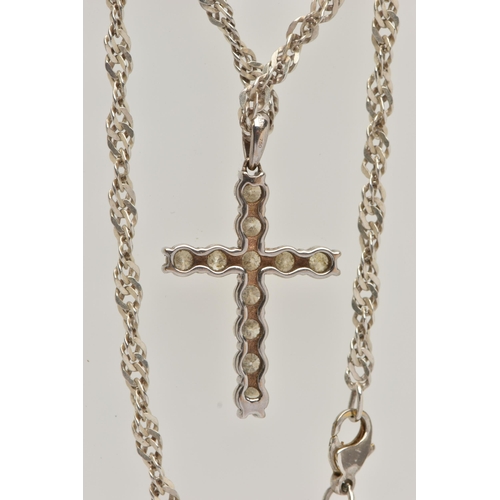 4 - A WHITE METAL DIAMOND CROSS PENDANT AND A CHAIN, the cross pendant claw set with eleven round brilli... 