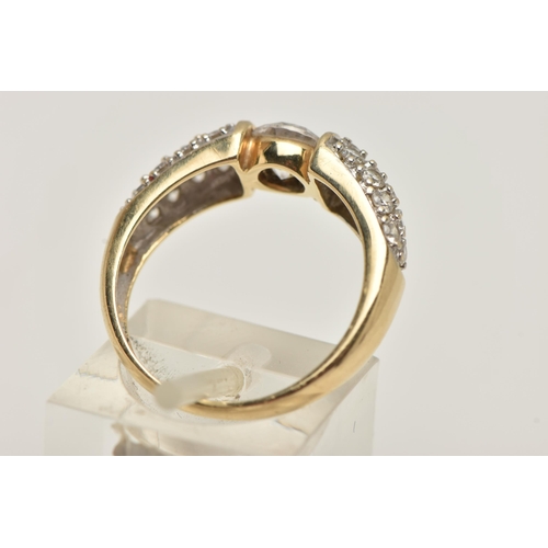 47 - A 14CT GOLD CUBIC ZIRCONIA RING, designed as a central circular colourless cubic zirconia flanked by... 