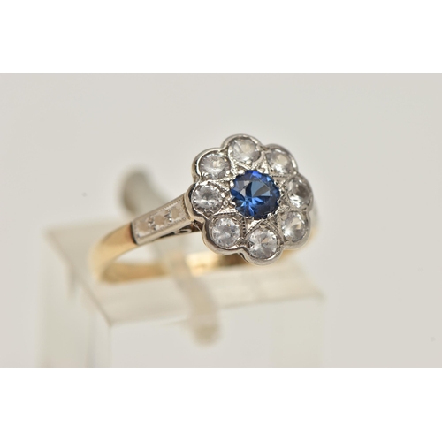 51 - A CLUSTER RING, designed as a central circular blue paste within a colourless paste surround, stampe... 