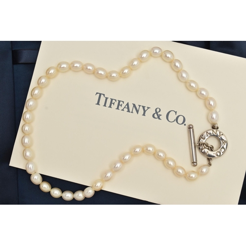 63 - A 'TIFFANY & CO' FRESH WATER PEARL TOGGLE NECKLACE, a string of forty four oval cultured fresh water... 