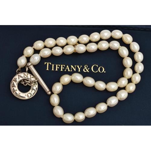 63 - A 'TIFFANY & CO' FRESH WATER PEARL TOGGLE NECKLACE, a string of forty four oval cultured fresh water... 