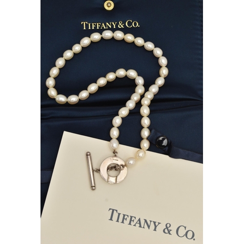 63 - A 'TIFFANY & CO' FRESH WATER PEARL TOGGLE NECKLACE, a string of forty four oval cultured fresh water... 