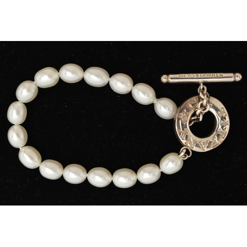 64 - A 'TIFFANY & CO' FRESH WATER PEARL TOGGLE BRACELET, a string of sixteen oval cultured fresh water pe... 