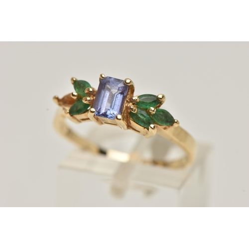 67 - A TANZANITE AND EMERALD RING, rectangular cut tanzanite set with marquise cut emeralds, prong set in... 