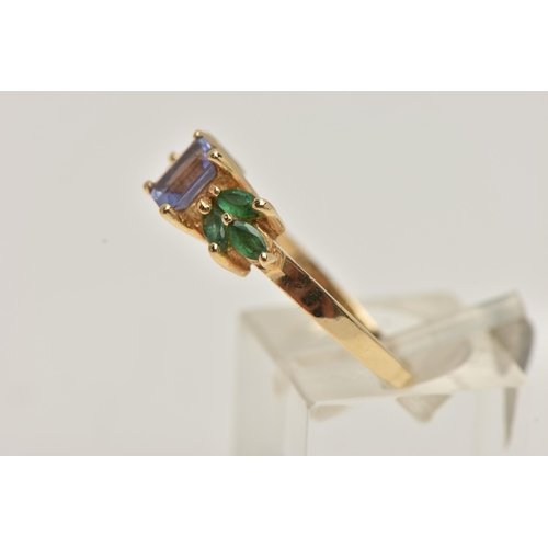 67 - A TANZANITE AND EMERALD RING, rectangular cut tanzanite set with marquise cut emeralds, prong set in... 