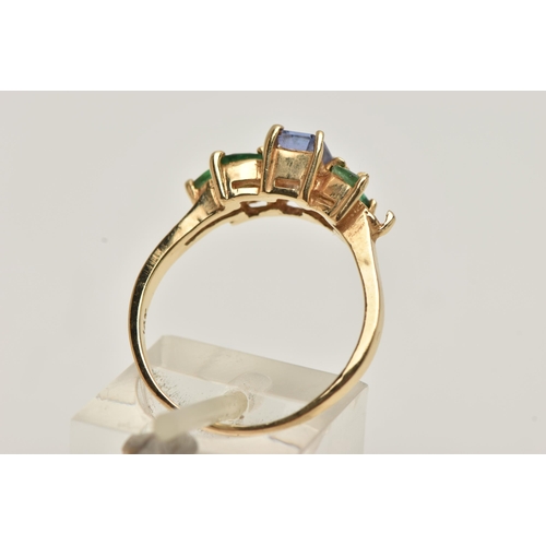 67 - A TANZANITE AND EMERALD RING, rectangular cut tanzanite set with marquise cut emeralds, prong set in... 