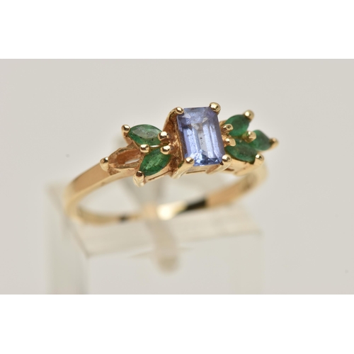 67 - A TANZANITE AND EMERALD RING, rectangular cut tanzanite set with marquise cut emeralds, prong set in... 