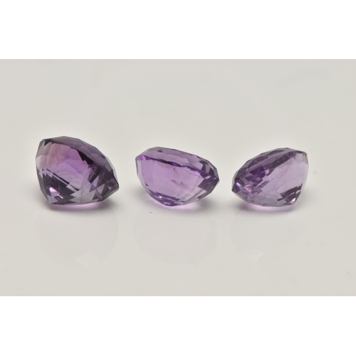 74 - THREE LOOSE OVAL CUT AMETHYSTS, largest stone measures approximately 12mm length x 9.5mm width,