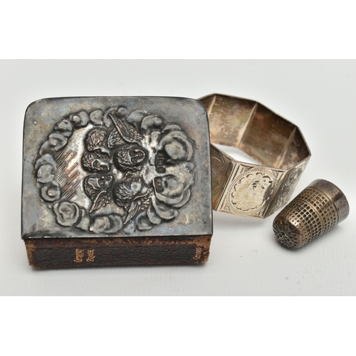 104 - A MINIATURE BIBLE, THIMBLE AND A NAPKIN RING, silver embossed cherub front to the bible hallmarked B... 