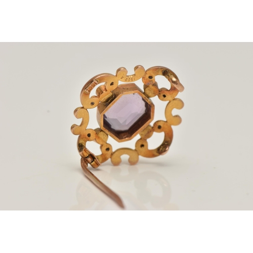 81 - A YELLOW METAL AMETHYST AND SEED PEARL BROOCH, open work scrolling brooch set with a central emerald... 