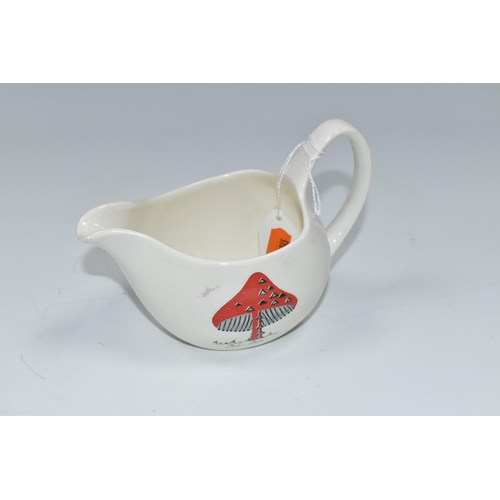 314 - THREE PIECES OF MIDWINTER POTTERY, comprising a Jessie Tait 'Toadstools' pattern cream jug on the Fa... 