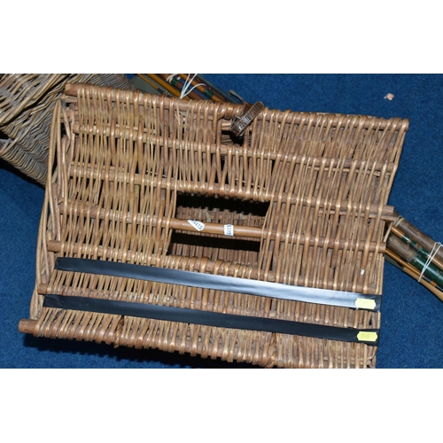 316 - TWO WICKER FISHING BASKETS AND A GROUP OF VINTAGE FISHING RODS AND REELS, comprising two hinged fish... 