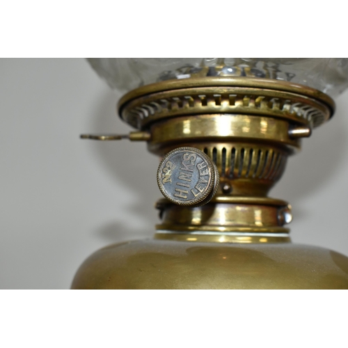 320 - AN ARTS & CRAFTS BRASS AND COPPER OIL LAMP IN THE STYLE OF W.A.S. BENSON, the frilled green and clea... 