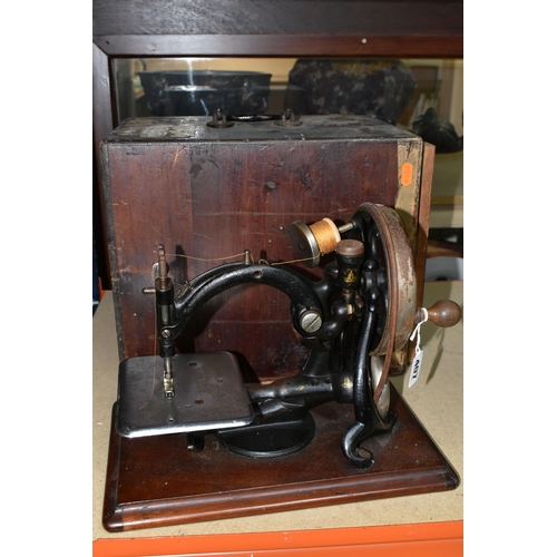 407 - A CASED WILLCOX & GIBBS PORTABLE SEWING MACHINE,  late nineteenth century, hand crank, remains of gi... 