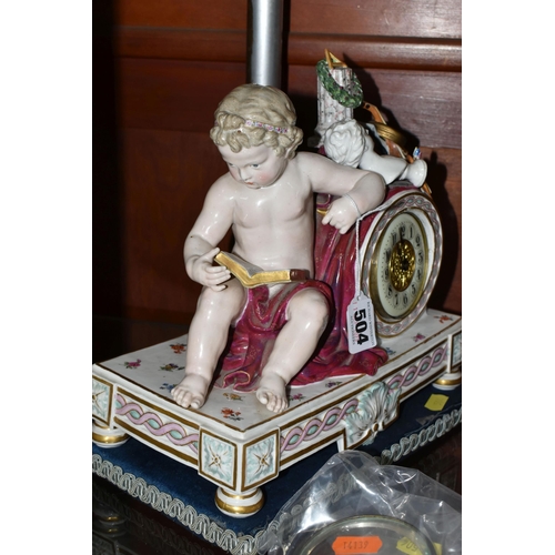 504 - A LATE 19TH CENTURY MEISSEN PORCELAIN CLOCK CASE, modelled with a seated putto reading, arm resting ... 